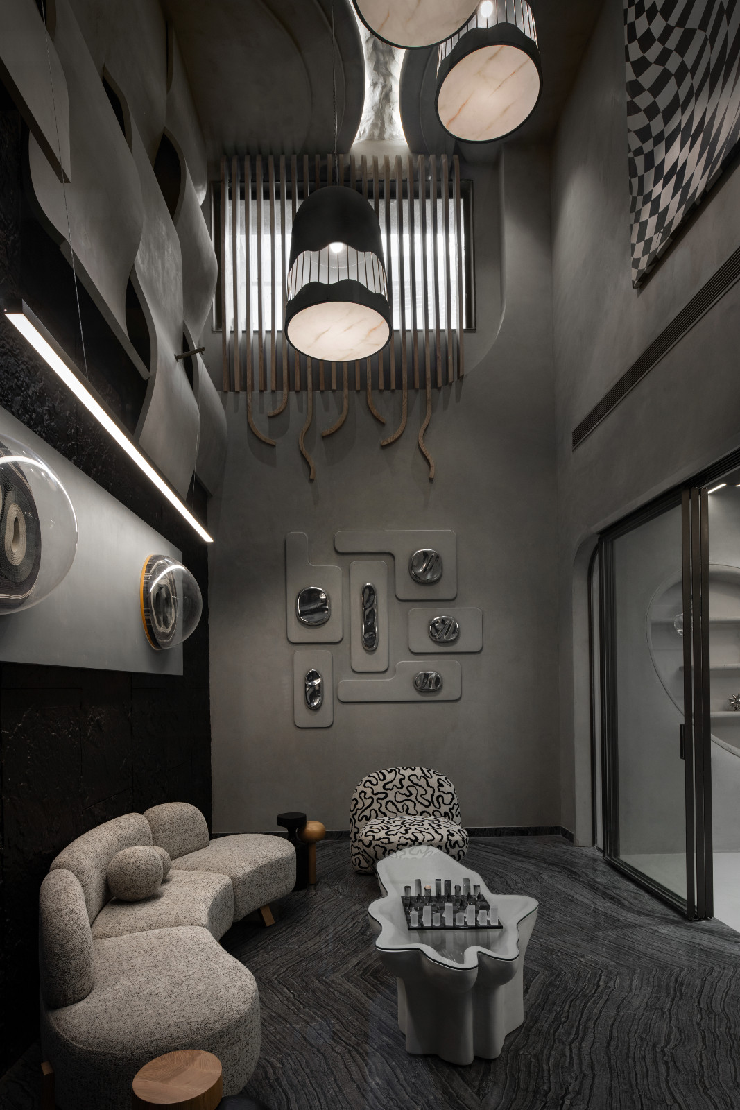 The living room of an avant-garde family home with brutalist elements in New Delhi, India designed by Spaces Architects @KA