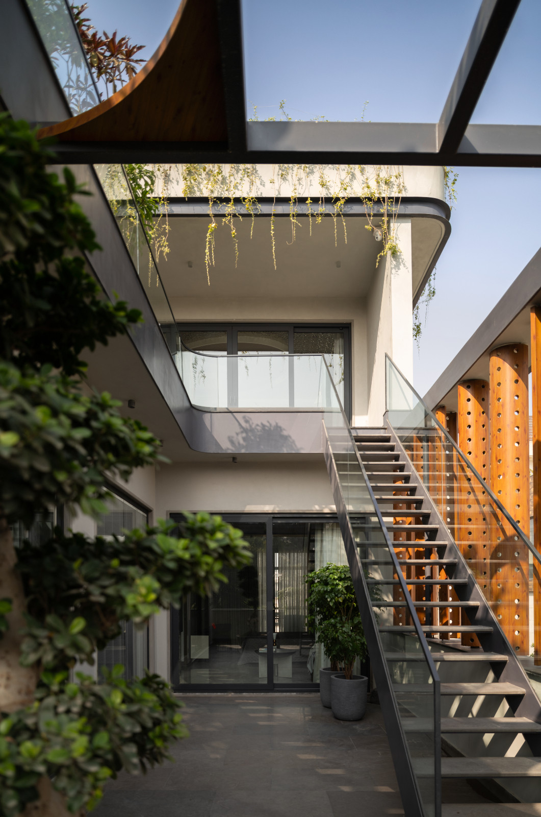 The garden of an avant-garde family home with brutalist elements in New Delhi, India designed by Spaces Architects @KA