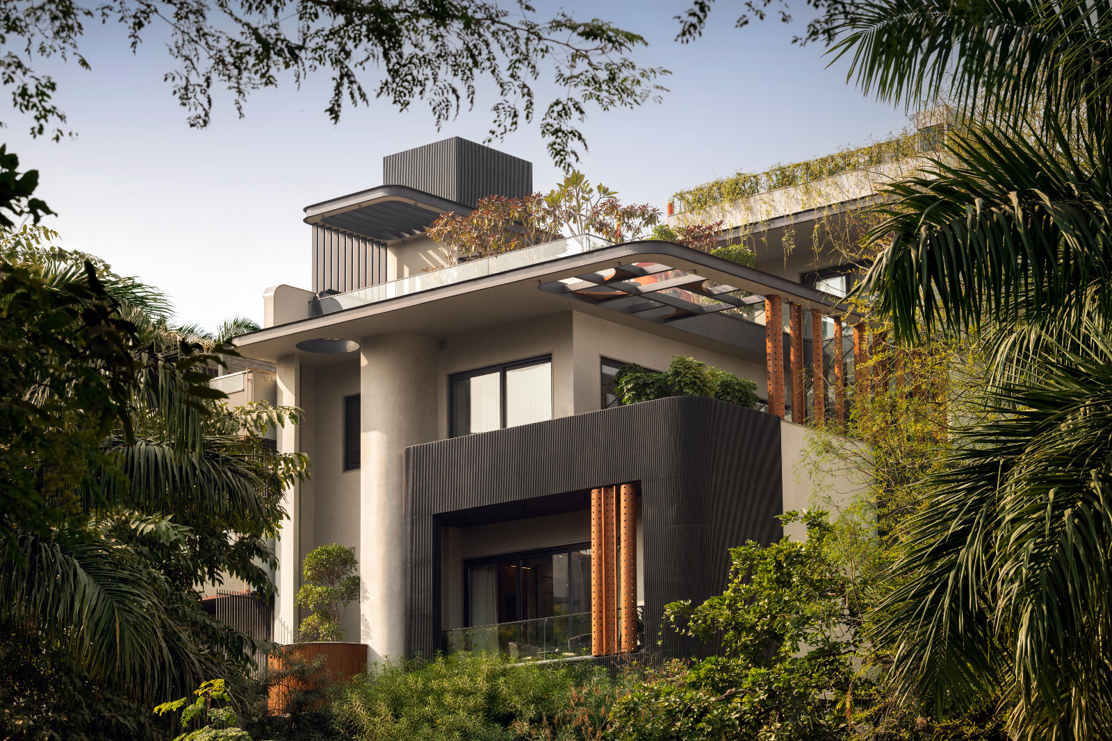 An external shot of an avant-garde family home with brutalist elements in New Delhi, India designed by Spaces Architects @KA