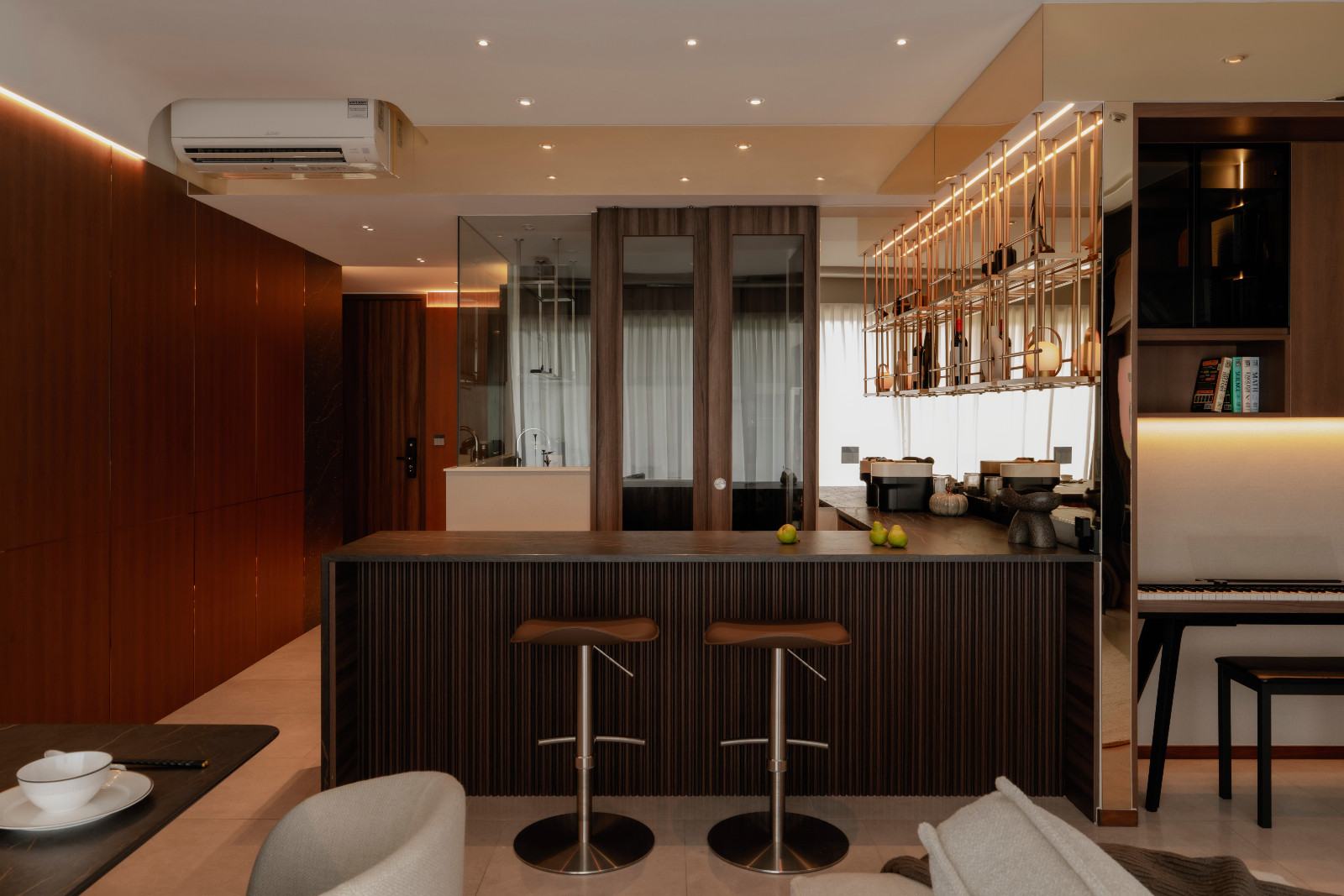 The bar and dry kitchen evoke the polish and openness of a showflat while remaining liveable