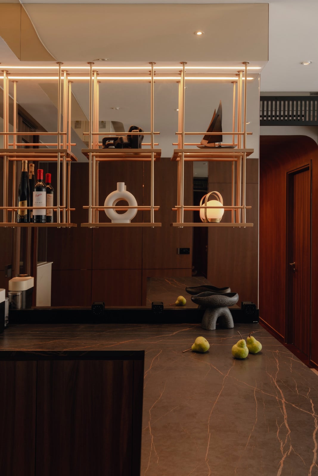 This corner of the dry kitchen is softly illuminated by lighting from Sol Luminaire and visually enlarged by the strategic placement of mirrors
