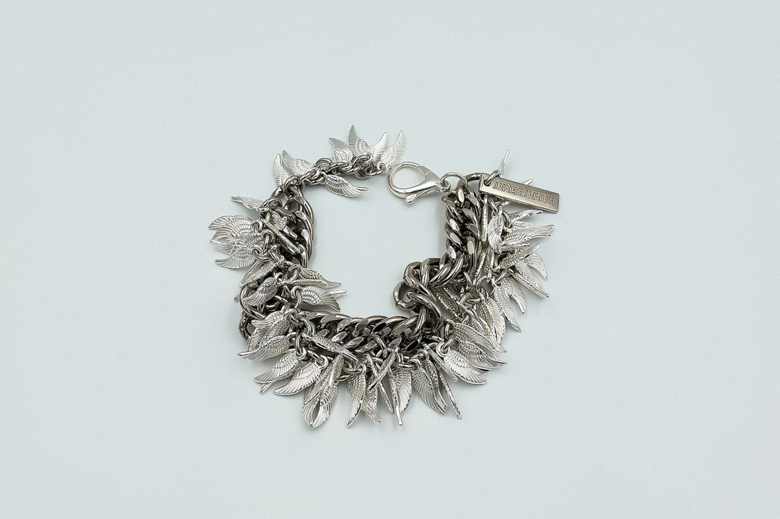 Silver charm bracelet, adorned with angel wings.