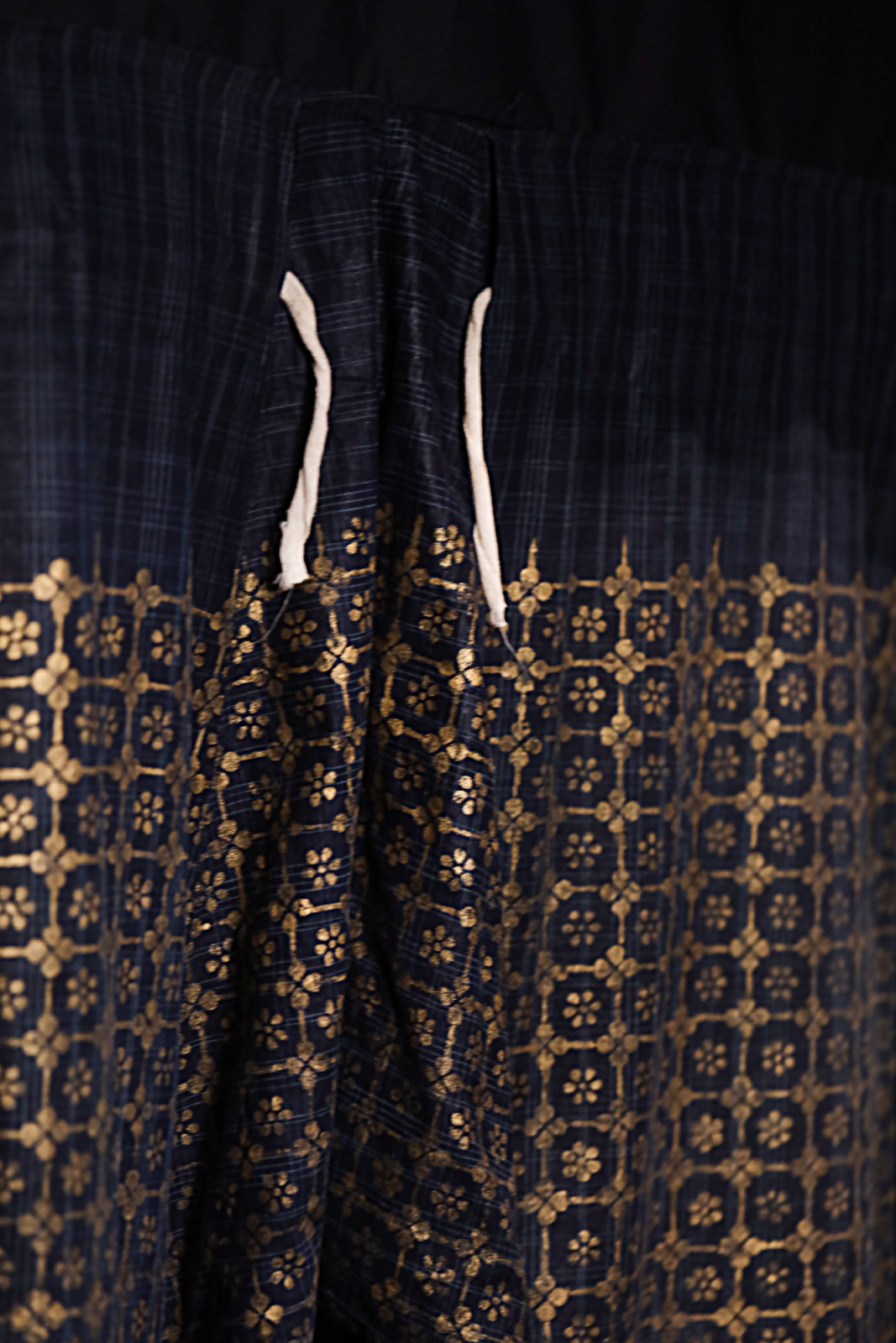 Applied by hand and imprinted onto fabric, the intricate patterns transformed textiles into garments befitting royalty