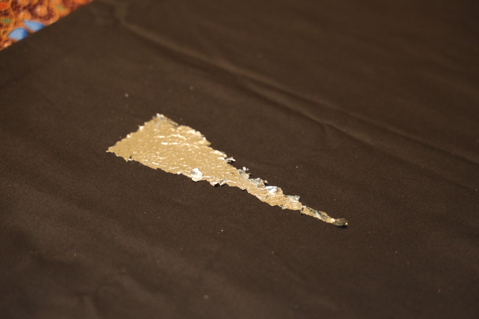 A demonstration of the traditional textile art of ‘telepuk’ using gilded gold leaf