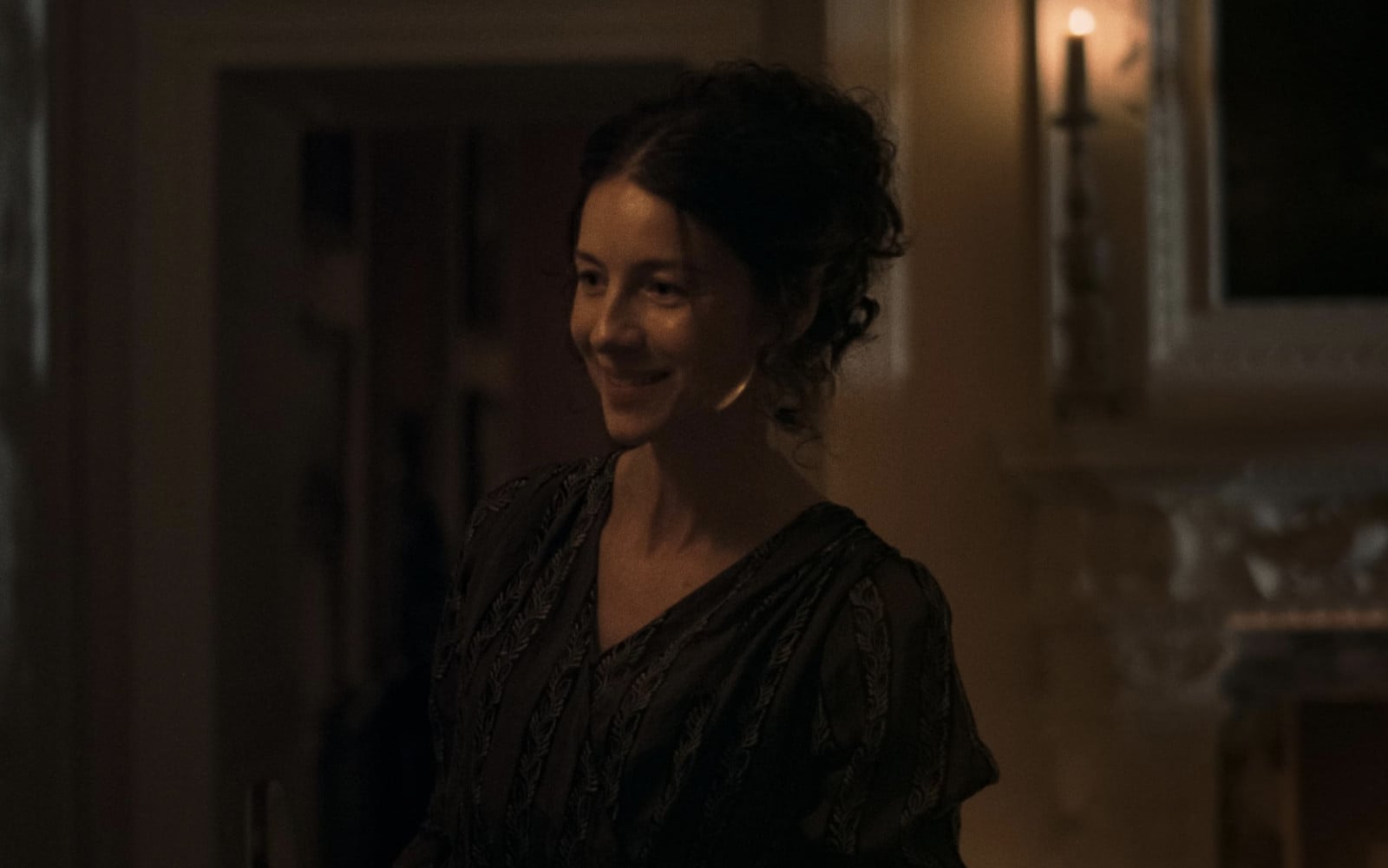 An actress in period attire smiles during filming for a highly anticipated 2026 production.