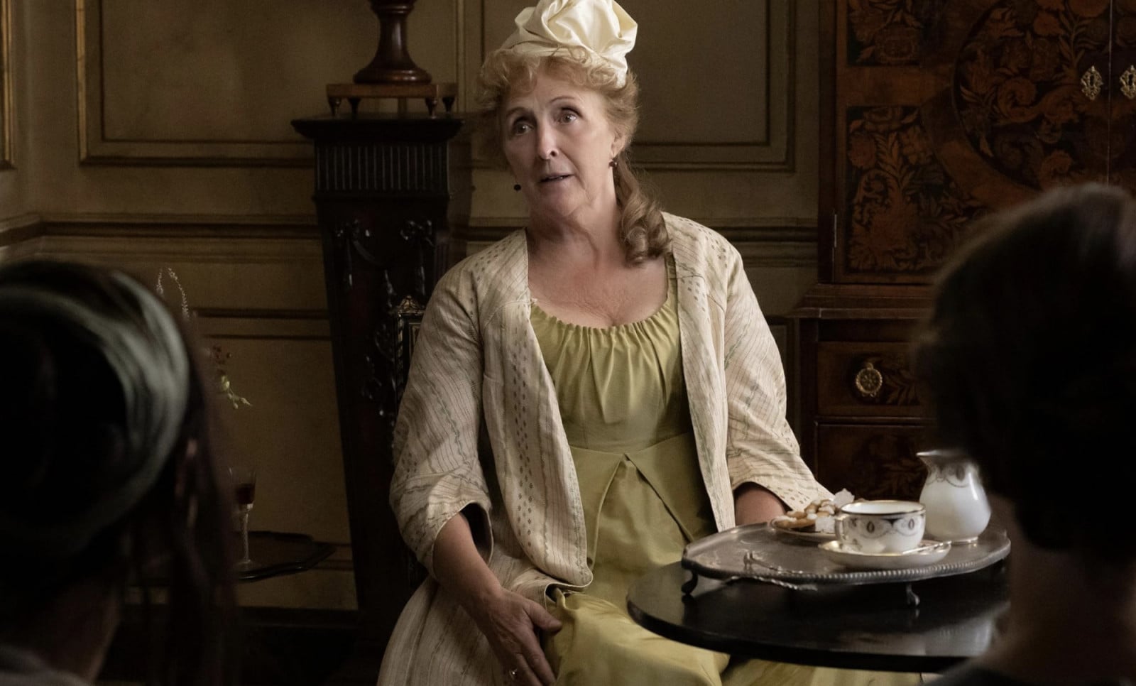 An actress from the 2026 Sense and Sensibility cast features in a period-appropriate drawing-room scene.