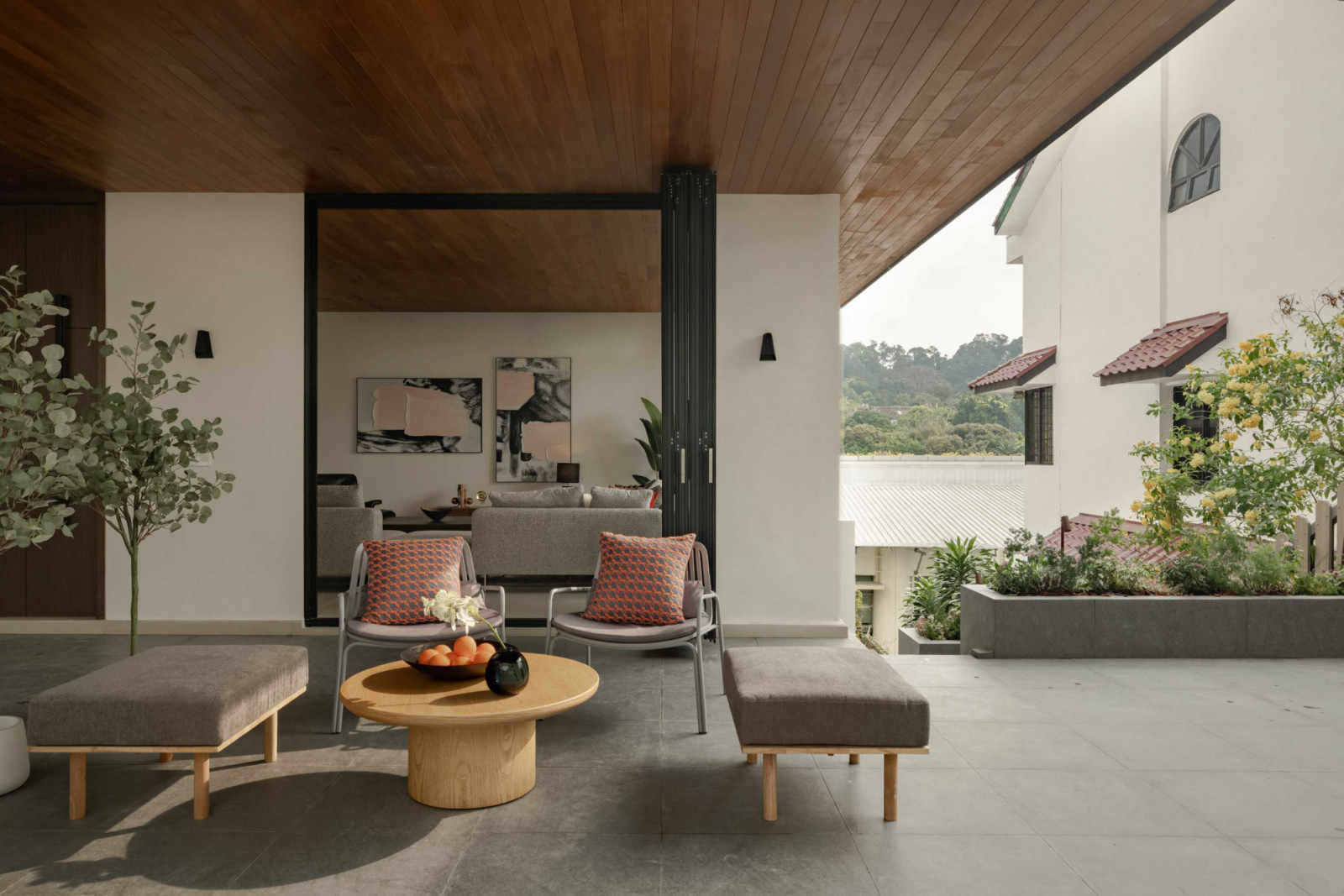 This covered outdoor deck extends the home’s timber ceiling motif
