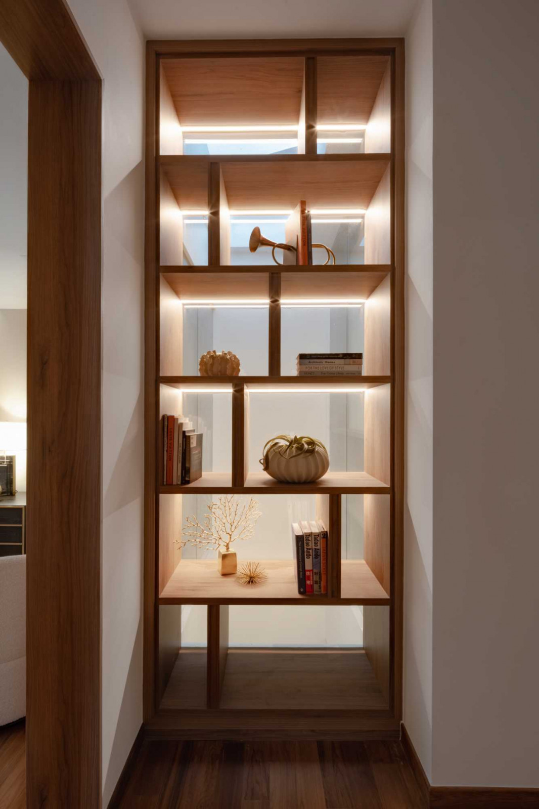 A backlit display niche brings warmth to the master bedroom