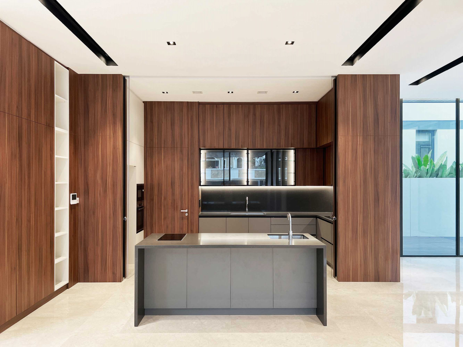 The property’s handsome kitchen features warm timber surfaces