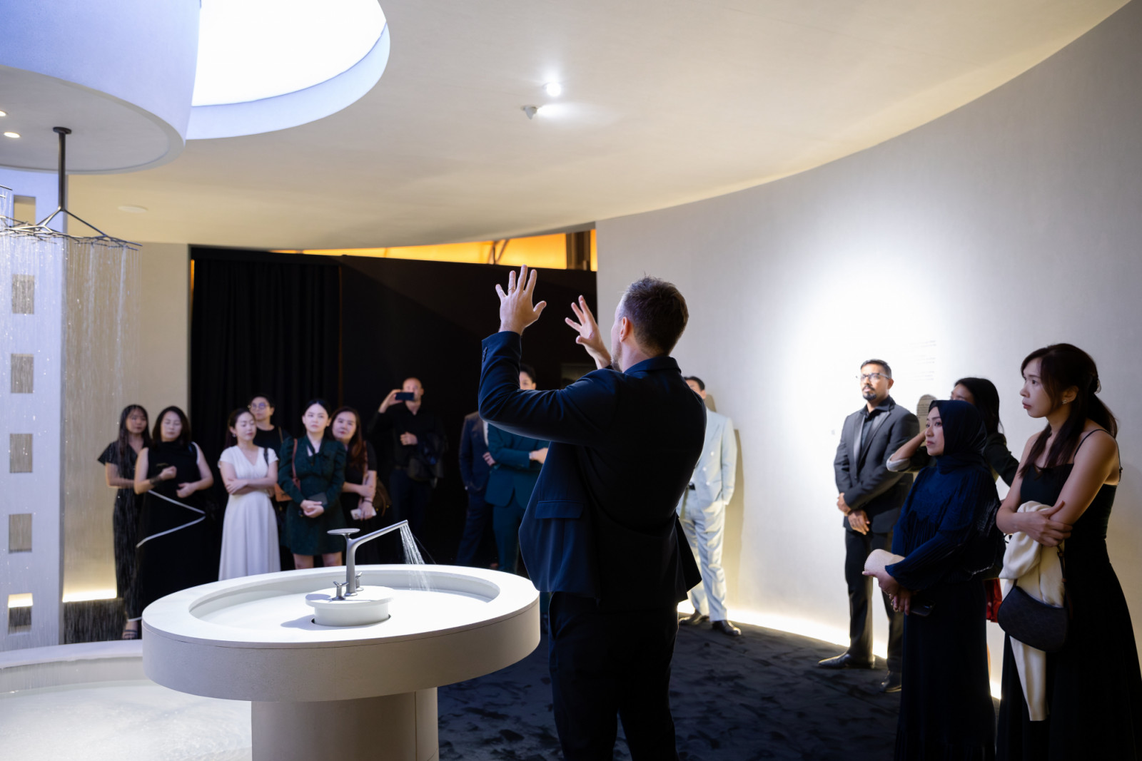 Guests gather around the Rainshower Icon 3D concept shower and Grohe Spa Icon 3D faucet in the first sanctum