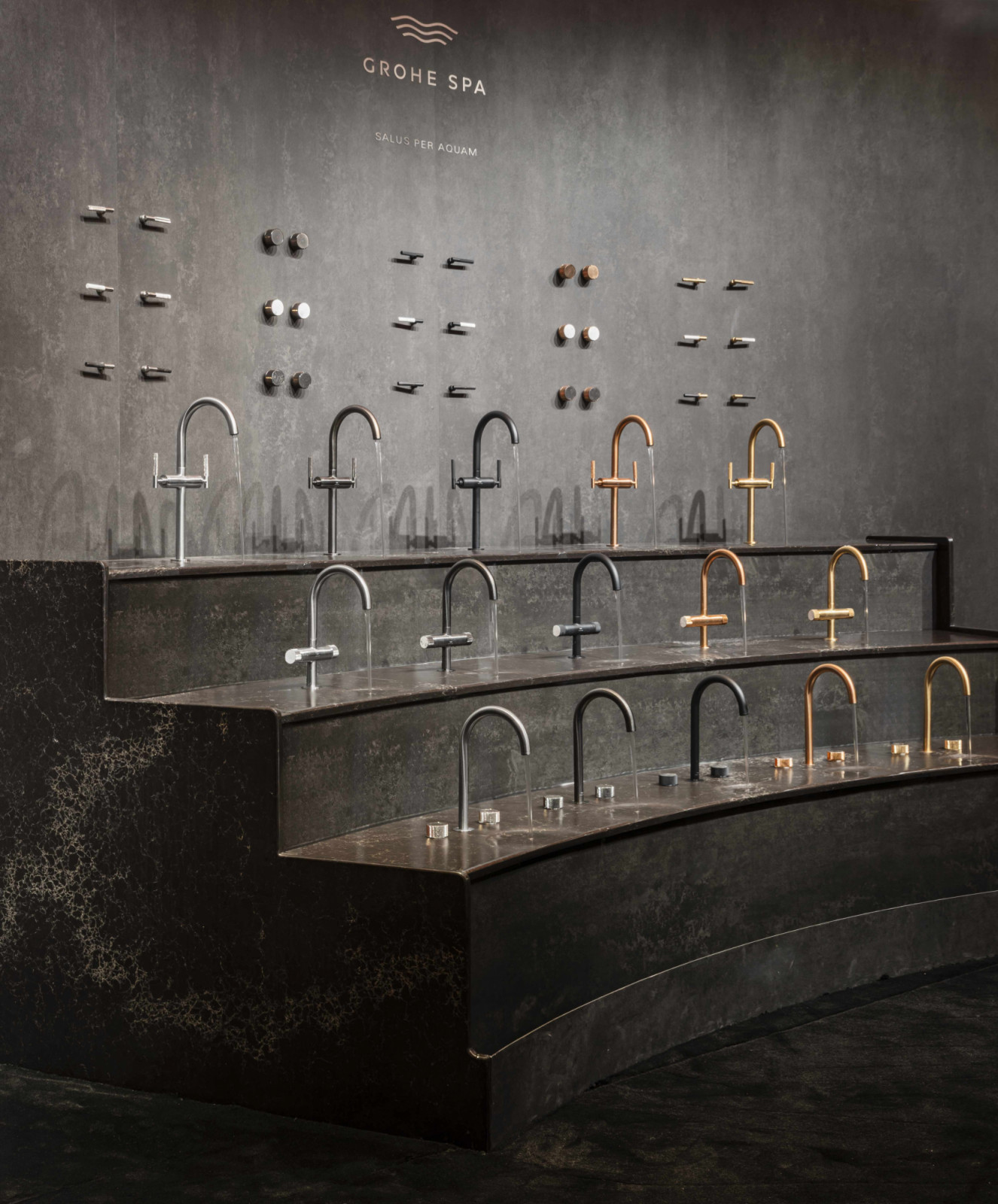 A tiered display of Grohe Spa Atrio Private Collection basin mixers and interchangeable handles in a range of finishes