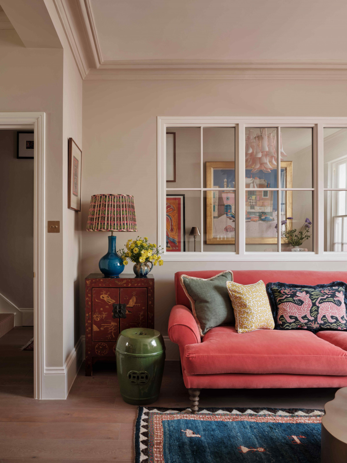 A bright pink sofa anchors the living room