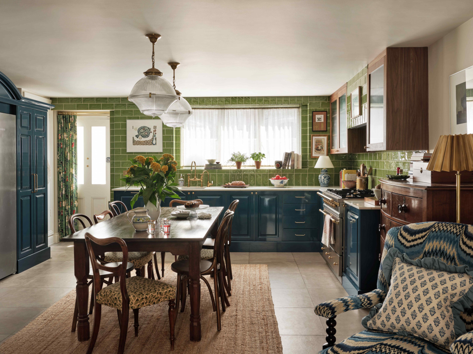 The kitchen and dining areas feel like a different experience from the adjacent living room