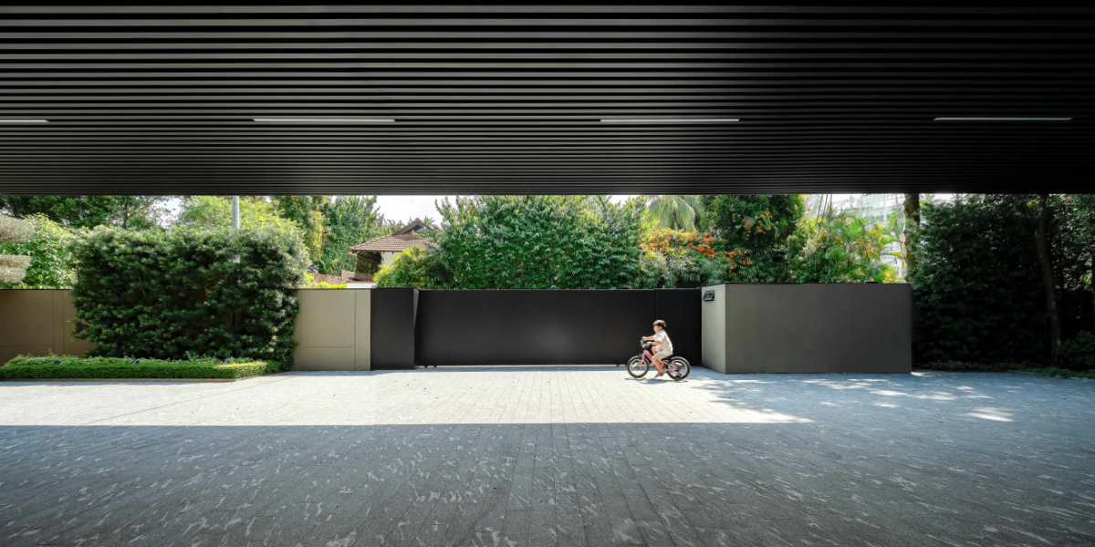 Beneath the generous overhang of this Good Class Bungalow, the forecourt doubles as a shaded drop-off and a safe place for the children to play