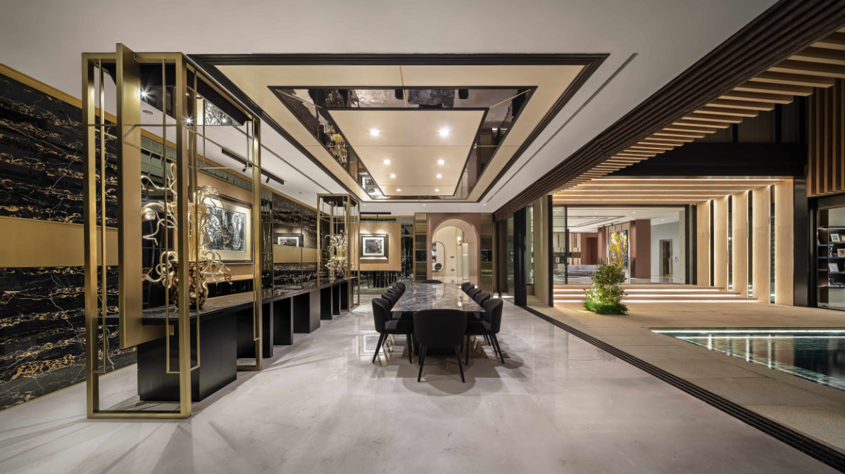 The formal dining room of this Good Class Bungalow by Lab Architects features two works by Picasso and opens onto the pool, its axis visible through the architectural framing