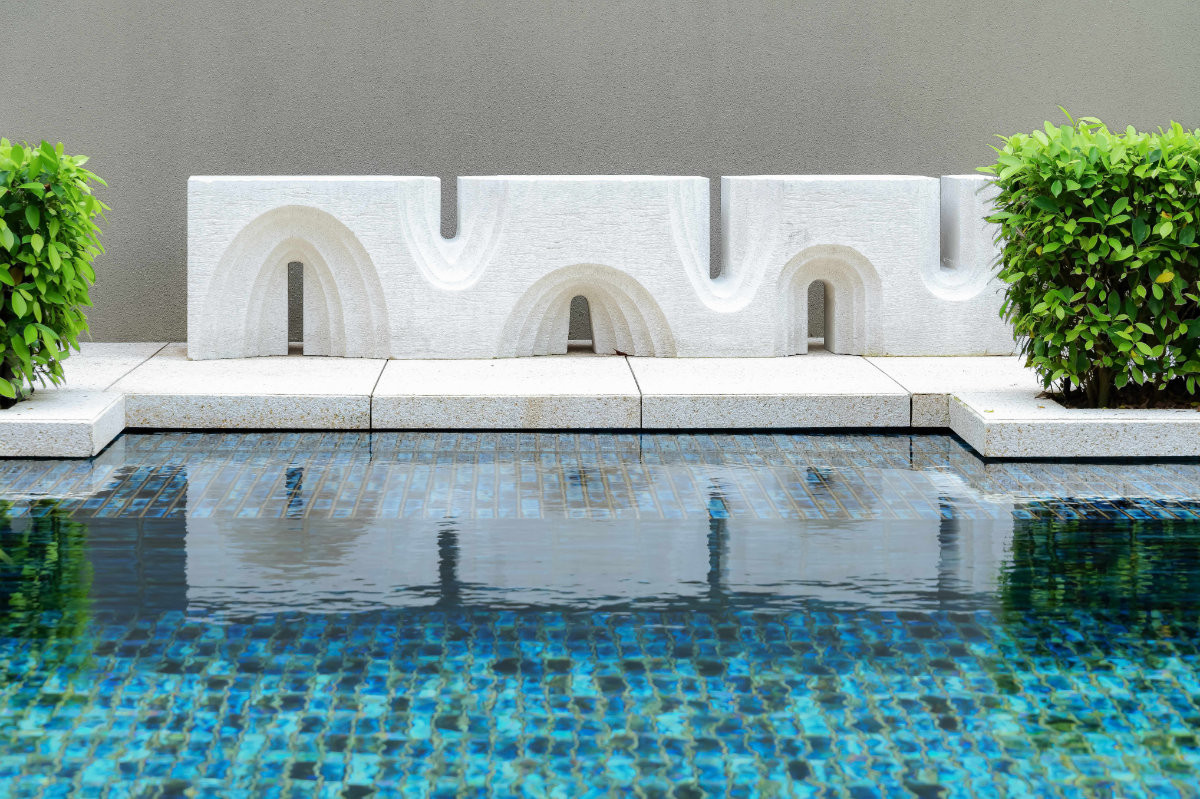 Carved from a single block of stone weighing around 700 kilograms, this sculpture of arches sits at the water’s edge, its reflection doubling the composition