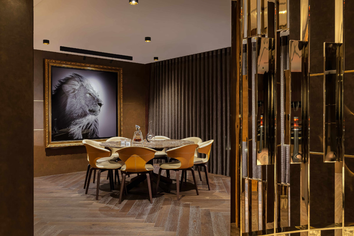 The whiskey room on the entertainment floor features Laurent Baheux’s “Lion in Compliance”