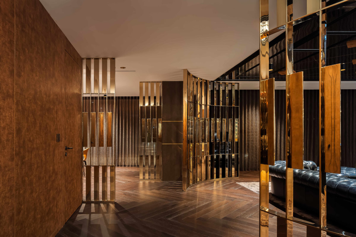 On the entertaining level, polished brass screens and herringbone floors set a moodier tone for evenings with friends
