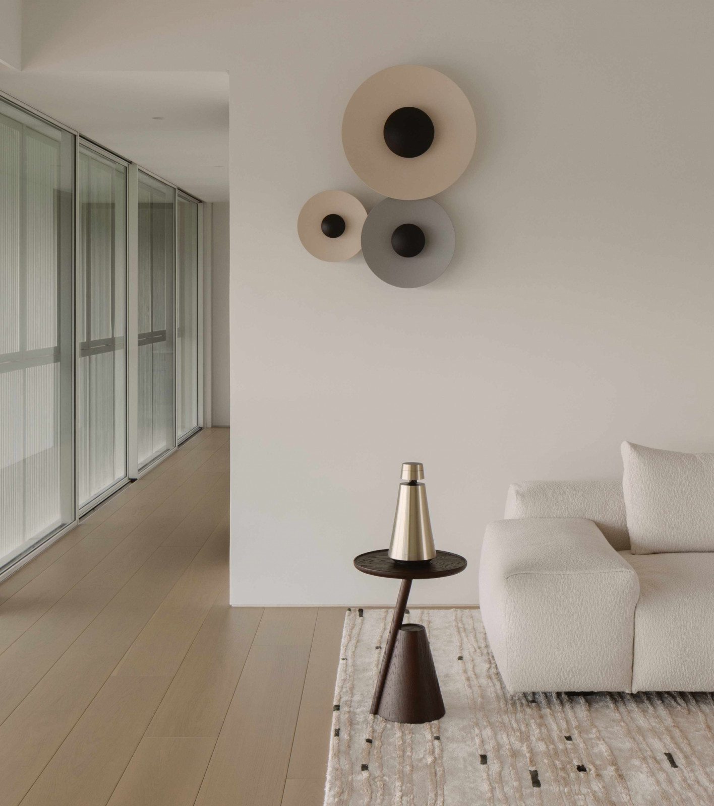 Wall-mounted discs and a Bang & Olufsen speaker bring visual interest to this corner of the family lounge