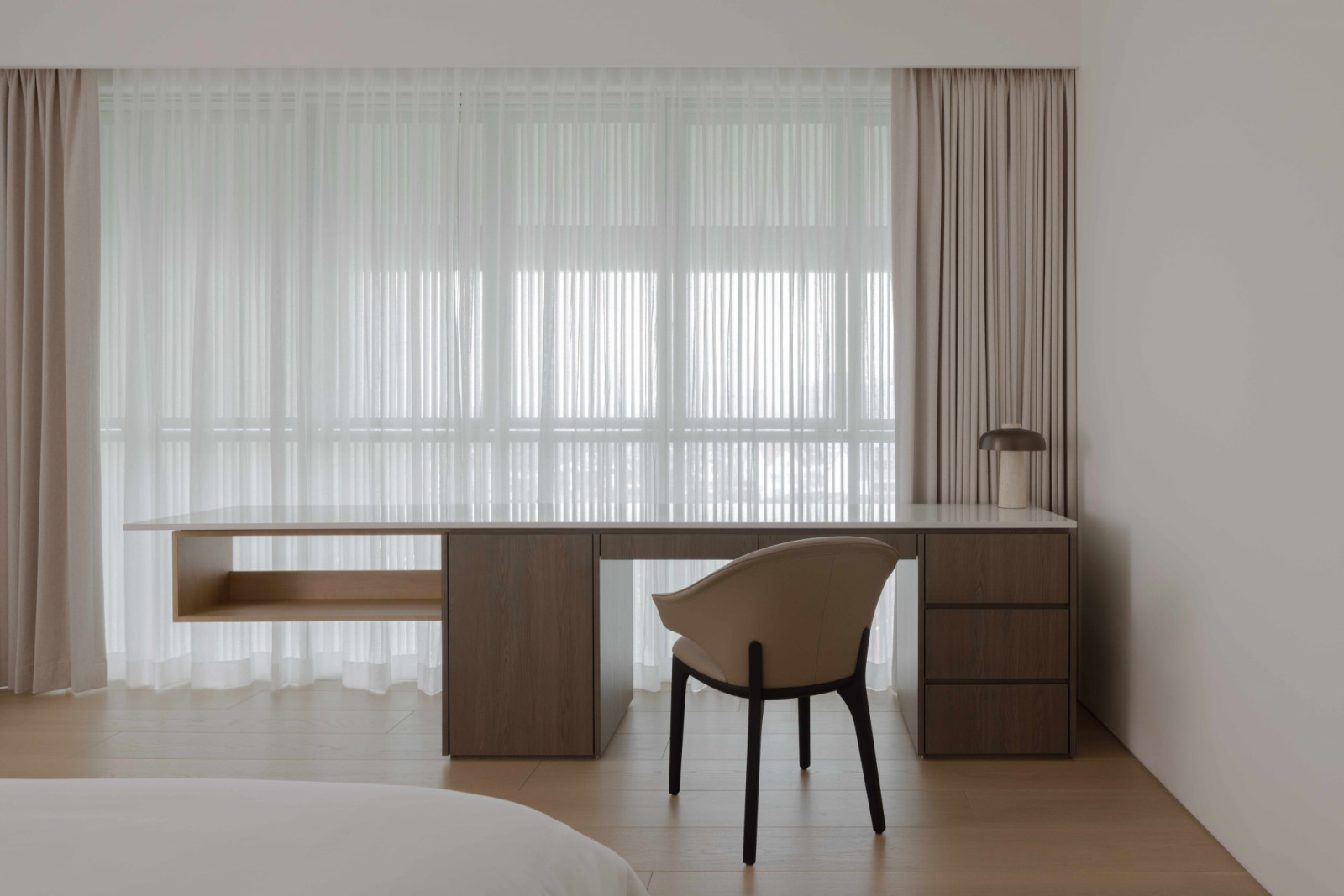 his study desk with a curtained window seat forms an introspective vignette
