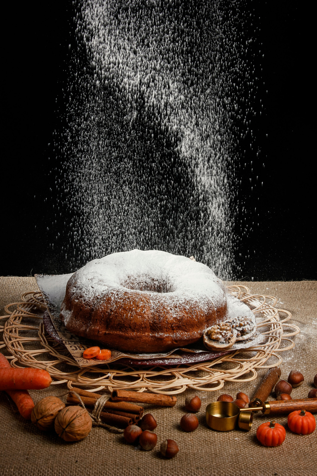 Confectioners' sugar dusts a spiced bundt cake, highlighting a common application for this fine crystalline sugar.
