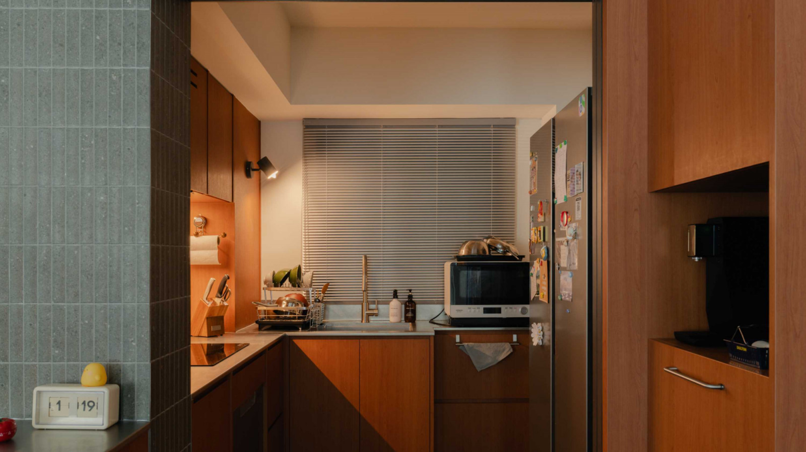 The functional yet snug kitchen is replete with classic wood fittings