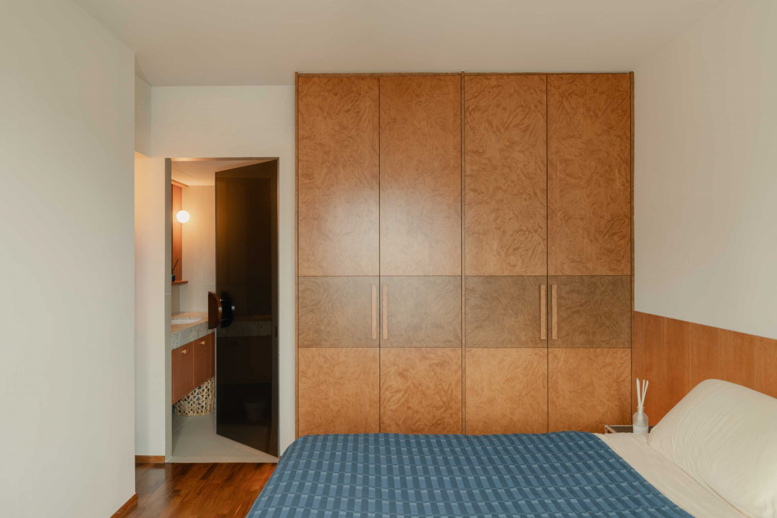 Burl-veneer wardrobes bring pattern and texture to the master bedroom
