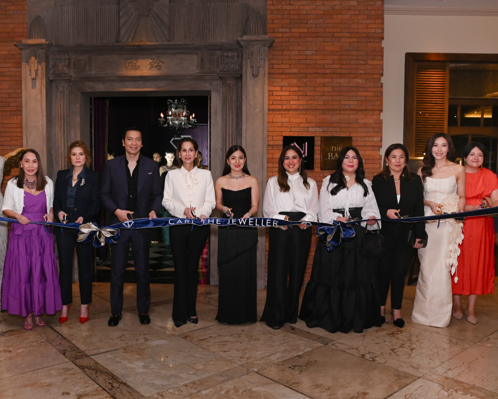 Prominent guests participate in the ribbon-cutting for Carl The Jeweller's grand opening.