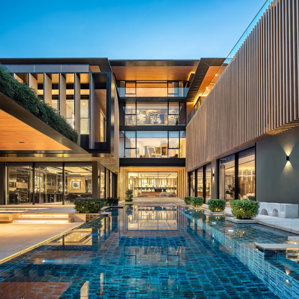 The lap pool runs between the two asymmetrical wings, linking the dining and living spaces