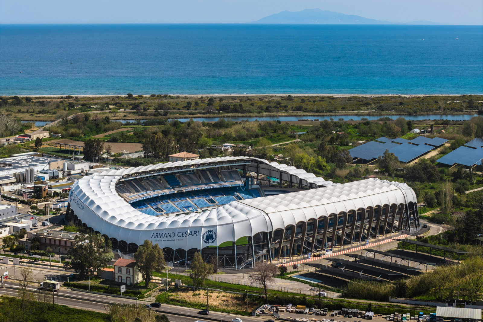 Armand Cesari Stadium, also known as the Stade de Furiani, sits between the Corsican coastline and the island’s mountains, its white canopy carried on a ring of arched supports (Photo: Banzaiprod)