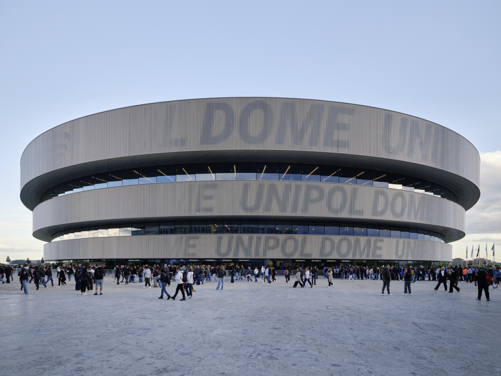 Crowds gather on the forecourt before an event at the arena, which was inaugurated as Arena Milano for the 2026 Winter Olympic Games (Photo: Noshe)