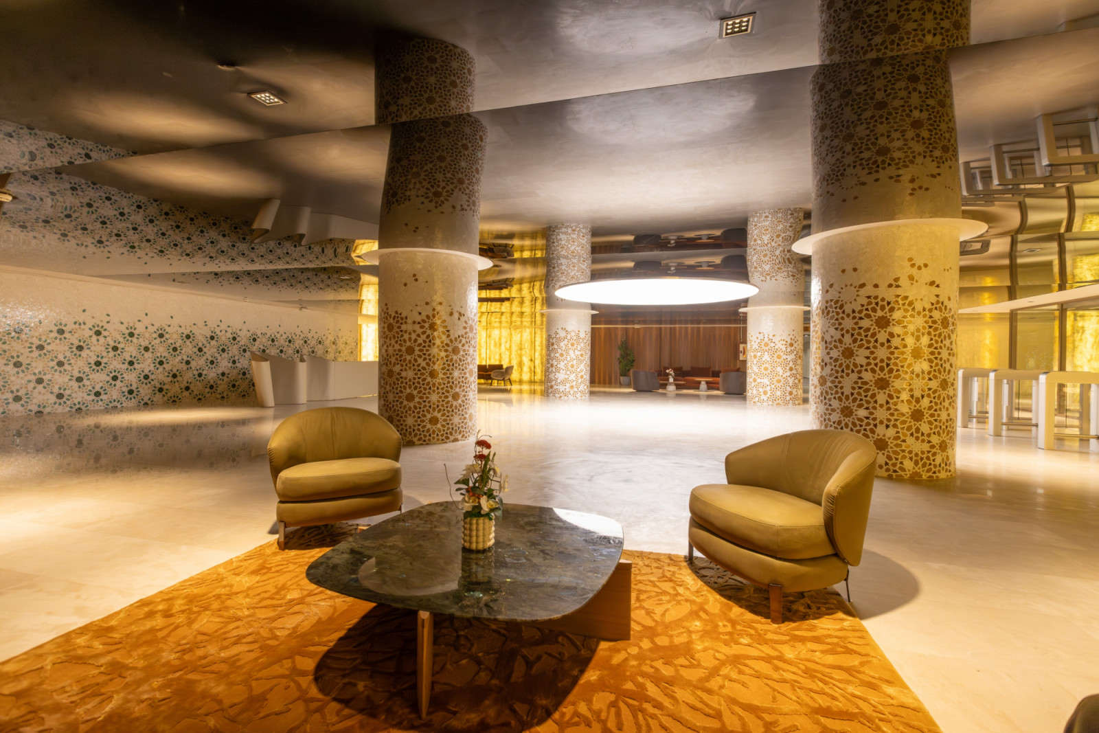 Geometric mosaic columns and backlit golden wall panels line the stadium’s reception areas, which pick up the colours of its exterior envelope (Photo: Société des Infrastructures Sportives de Rabat)