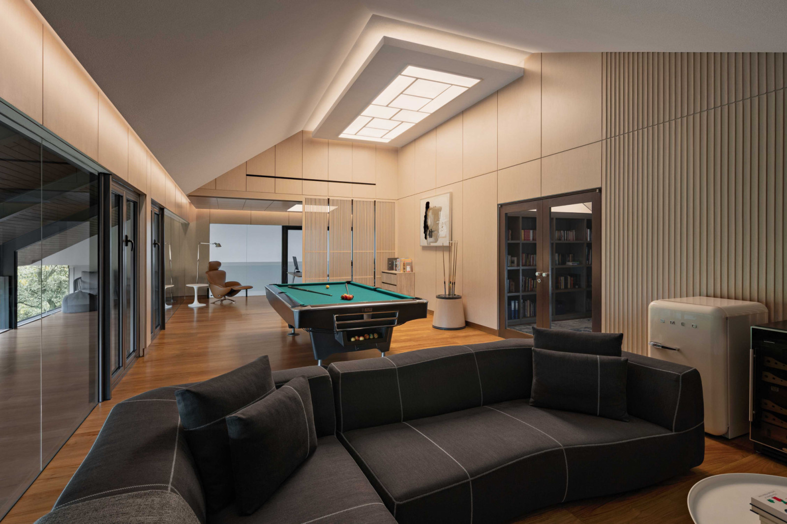 The expansive entertainment zone is equipped with a billiard table and a home-theatre setup, and connected to the study