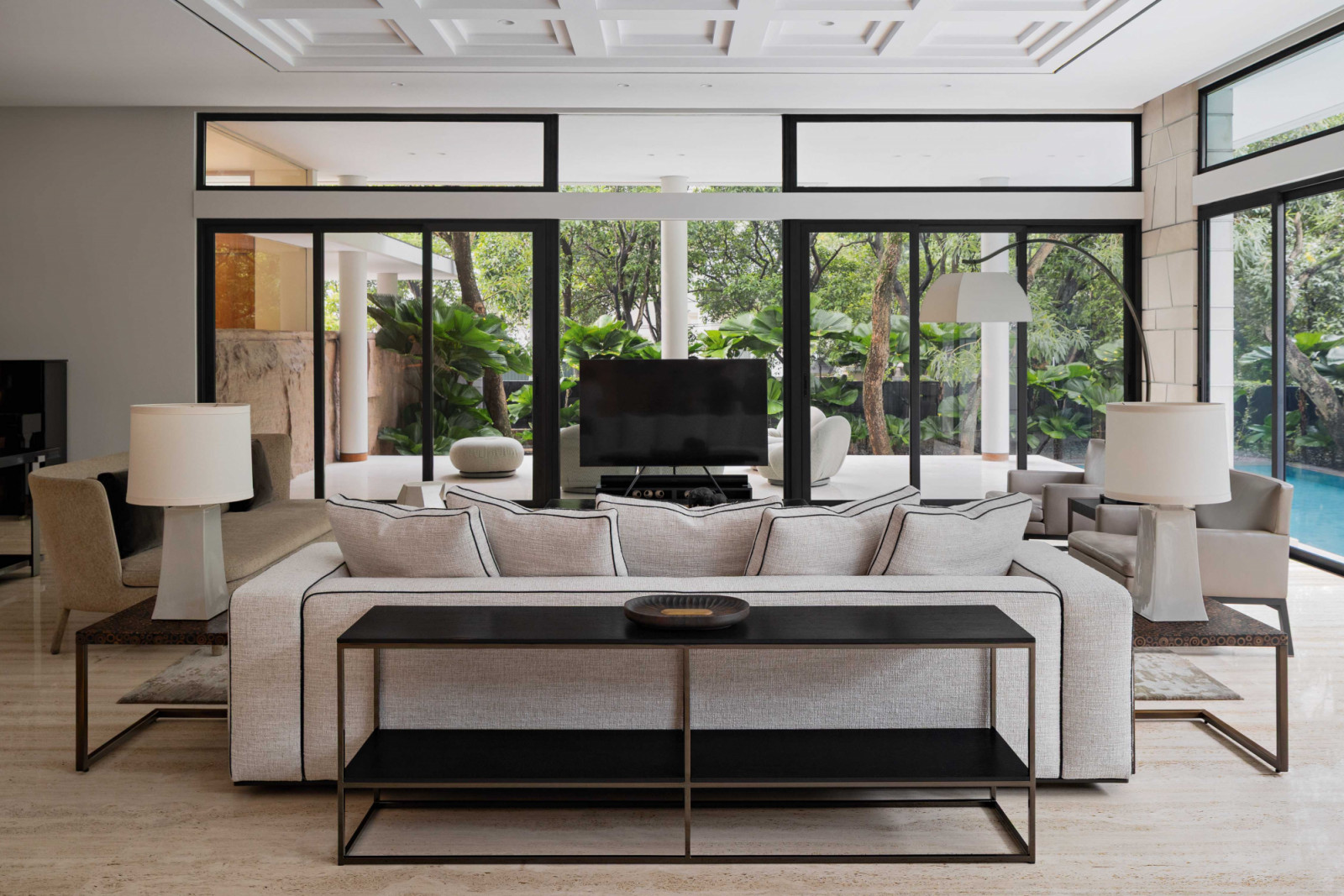 The living room is anchored by an elegant white couch