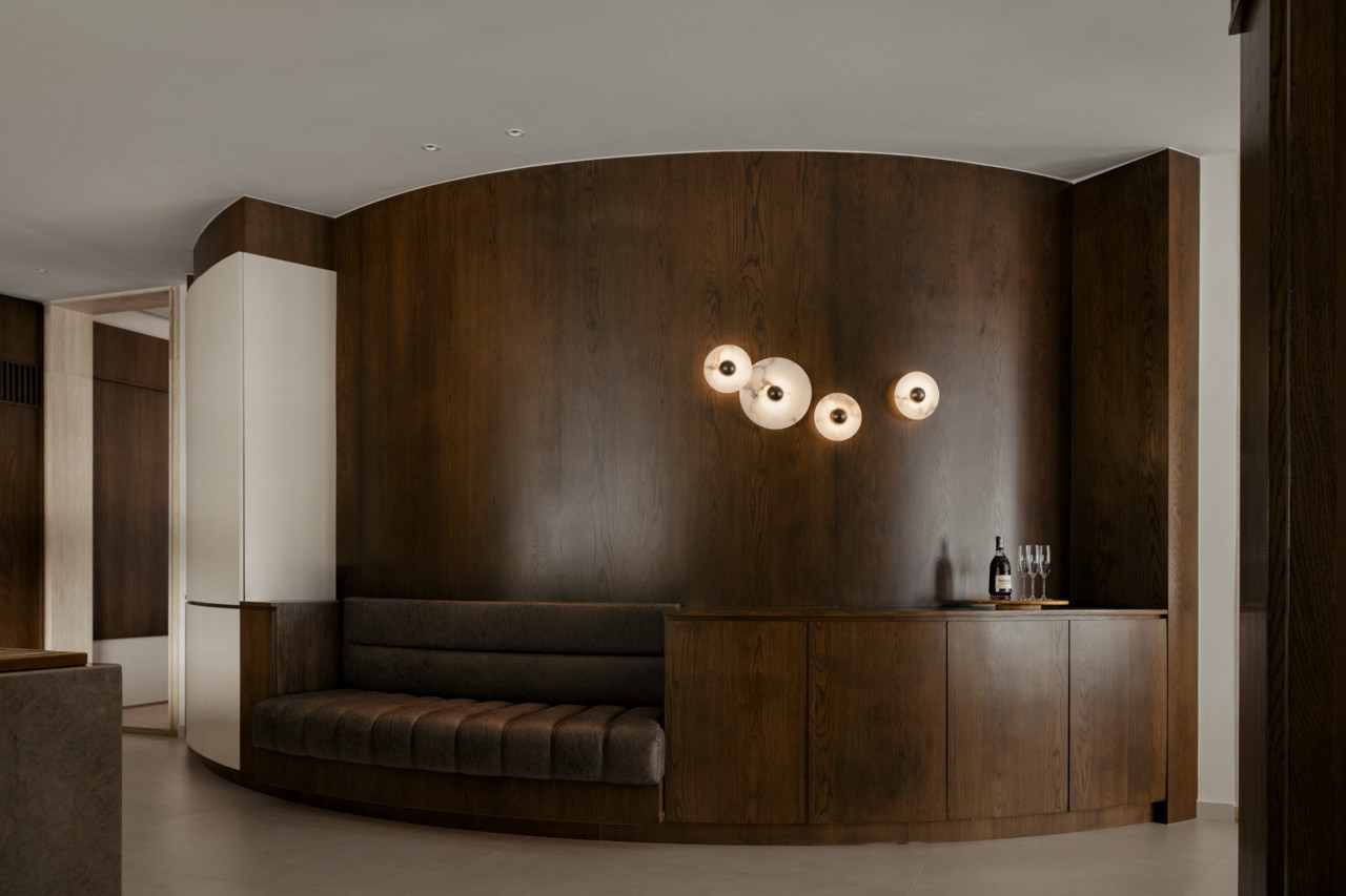 A upholstered banquette offers occasional seating