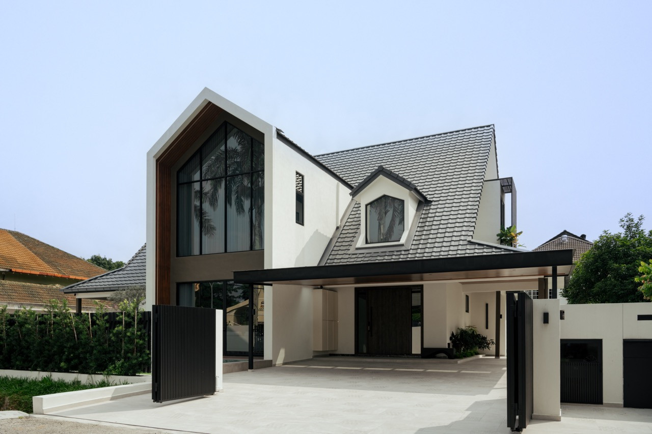 The new façade, with its pitched roof and floor-to-ceiling glazing, at dusk