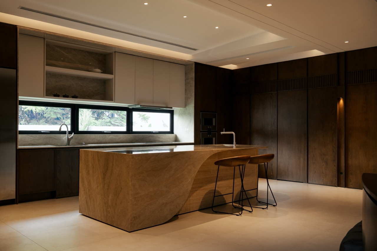 A sculptural stone island anchors the kitchen