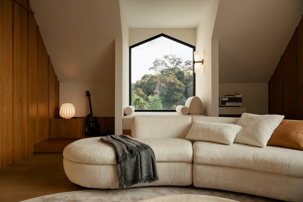 A gable-shaped window in the upstairs lounge echoes the pitched roof