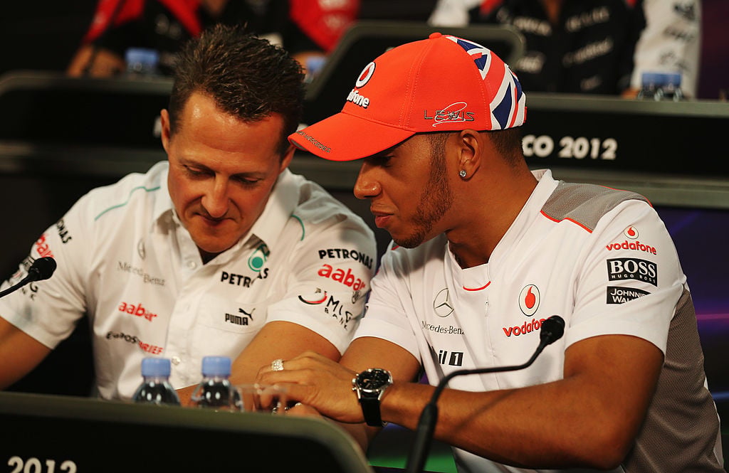 MONTE CARLO, MONACO - MAY 23: Lewis Hamilton (R) of Great Britain and McLaren talks with Michael Schumacher (L) of Germany and Mercedes GP at the drivers press conference during previews to the Monaco Formula One Grand Prix at the Monte Carlo Circuit on May 23, 2012 in Monte Carlo, Monaco. (Photo by Clive Mason/Getty Images)