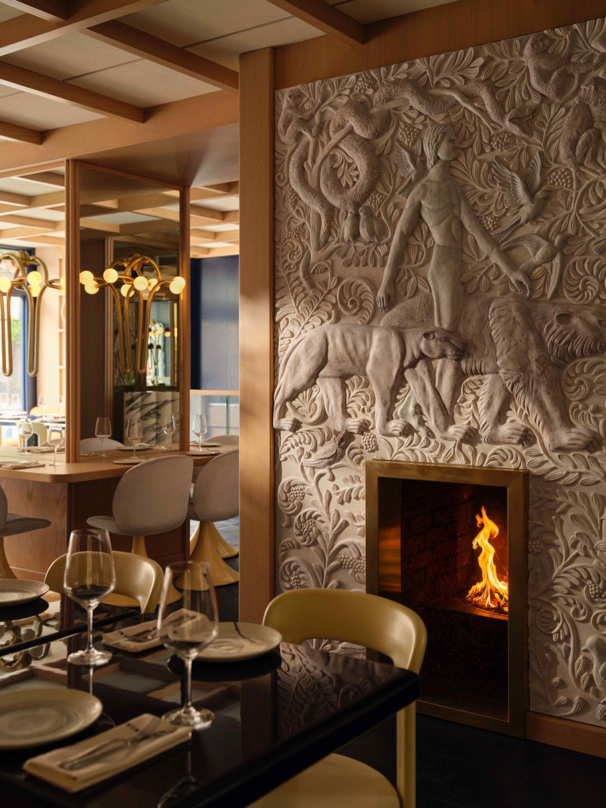 The original fireplace has been restored with custom bas-reliefs