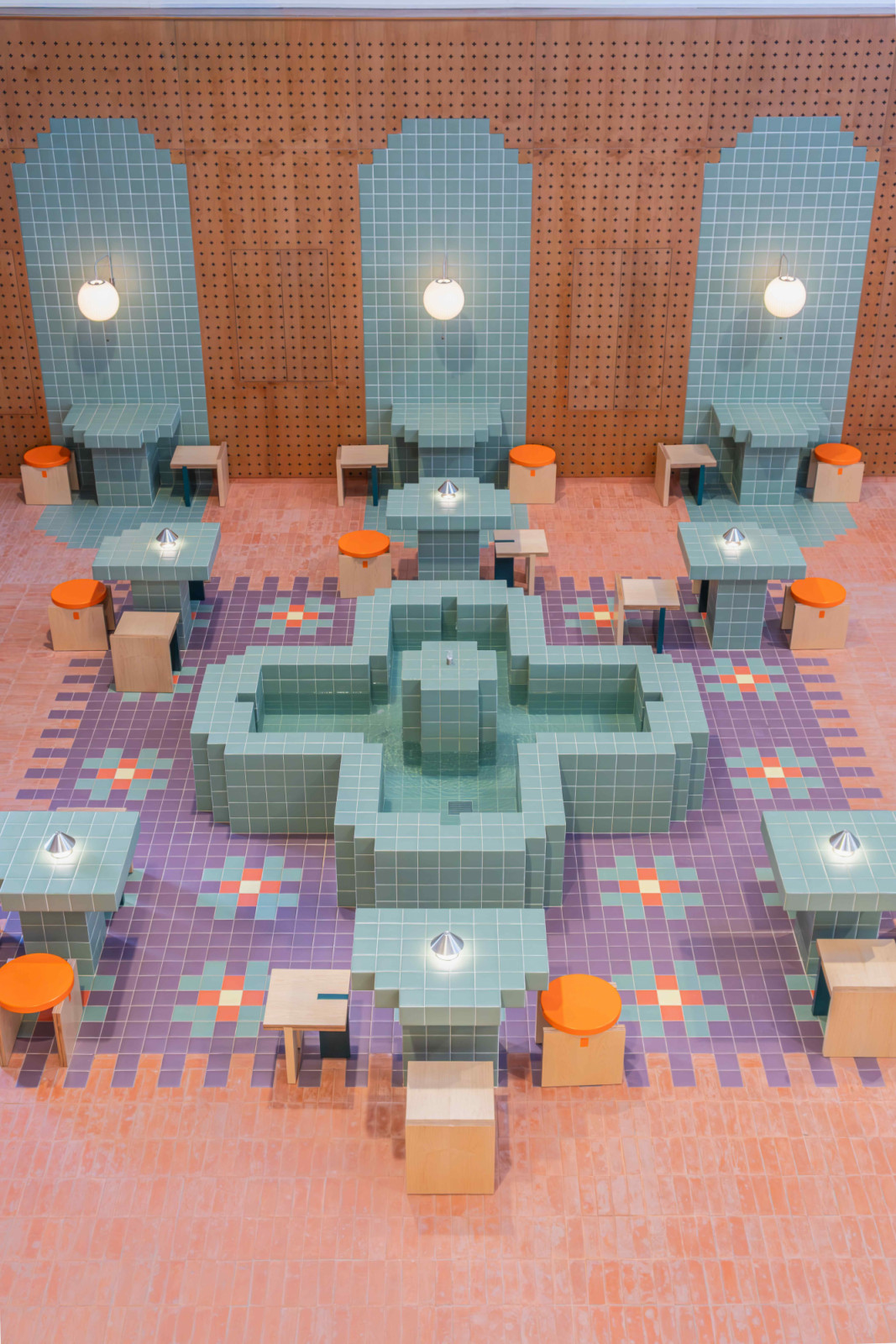 The venue space is anchored by a central community fountain