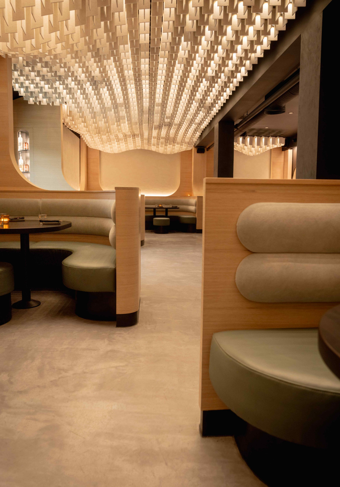 Curved white oak millwork references whisky barrels