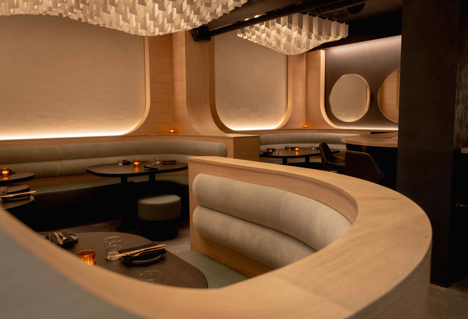 Intimate custom banquettes that ribbon through the space
