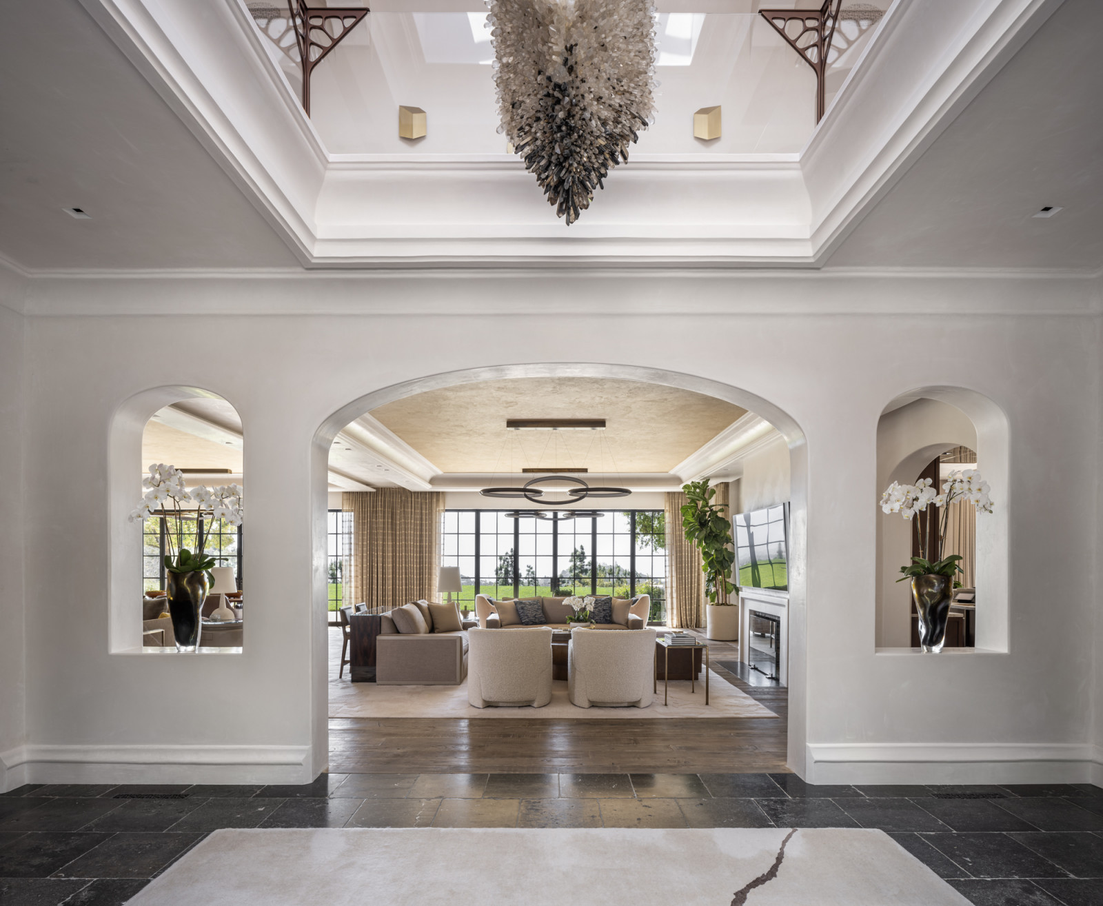The striking modern chandelier in the soaring entrance foyer