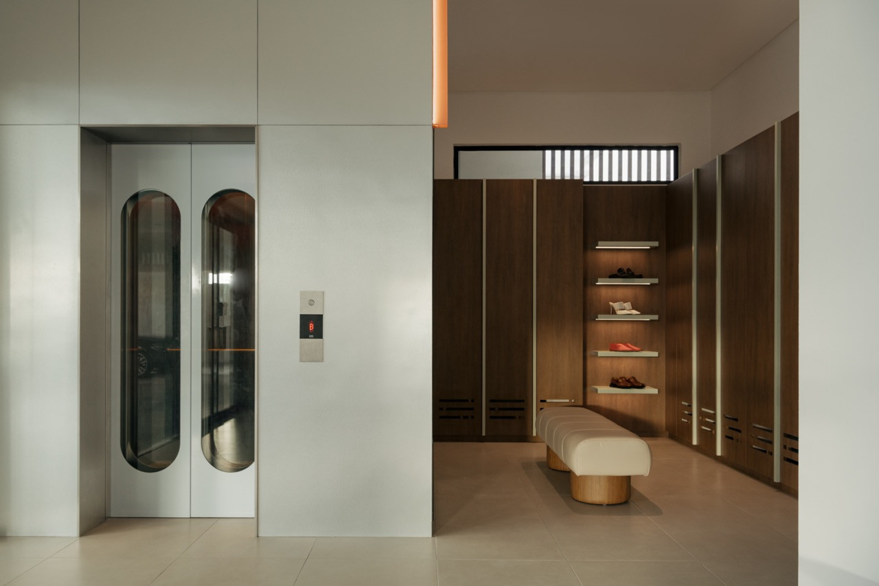 The home’s lift and an adjoining dressing area, finished in the same considered material palette as the rest of the house