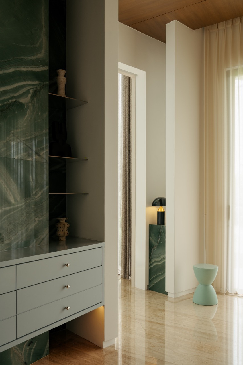 A hallway vignette showing the mix of stone and warm timber finishes used throughout the house