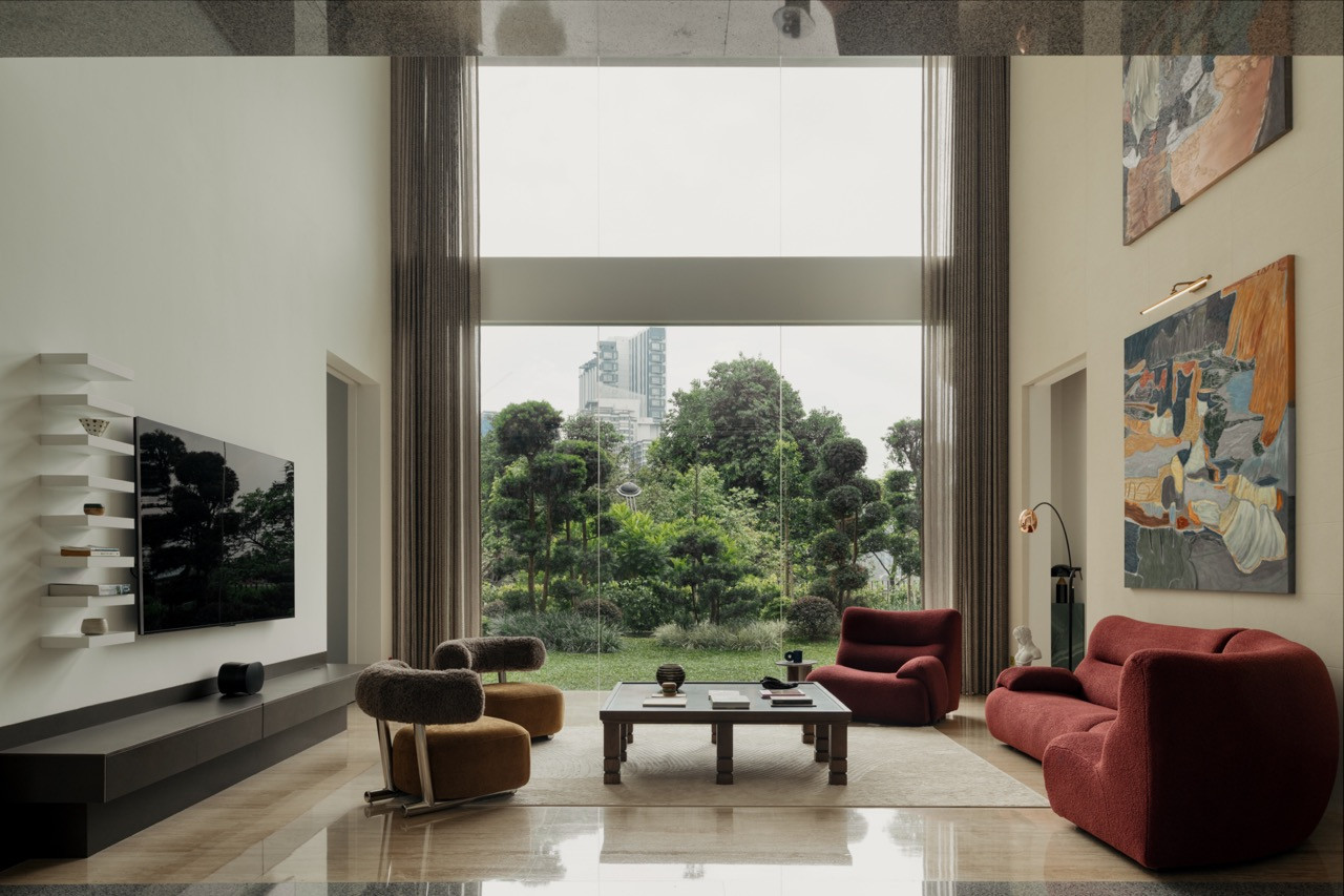 The double-height living room, with carefully chosen furniture and artwork, also offers a view of the garden