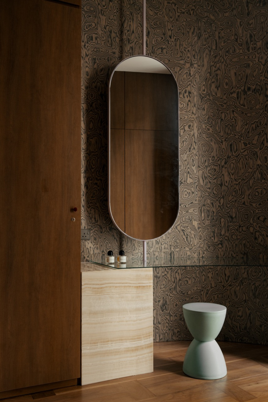 A bathroom vanity in stone and glass
