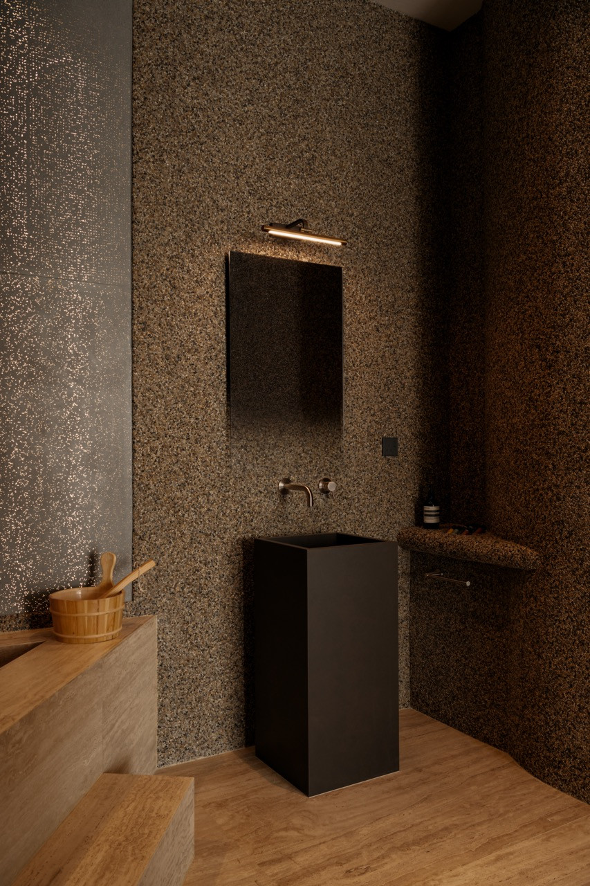 The monolithic sink keeps the material palette spare and monochromatic
