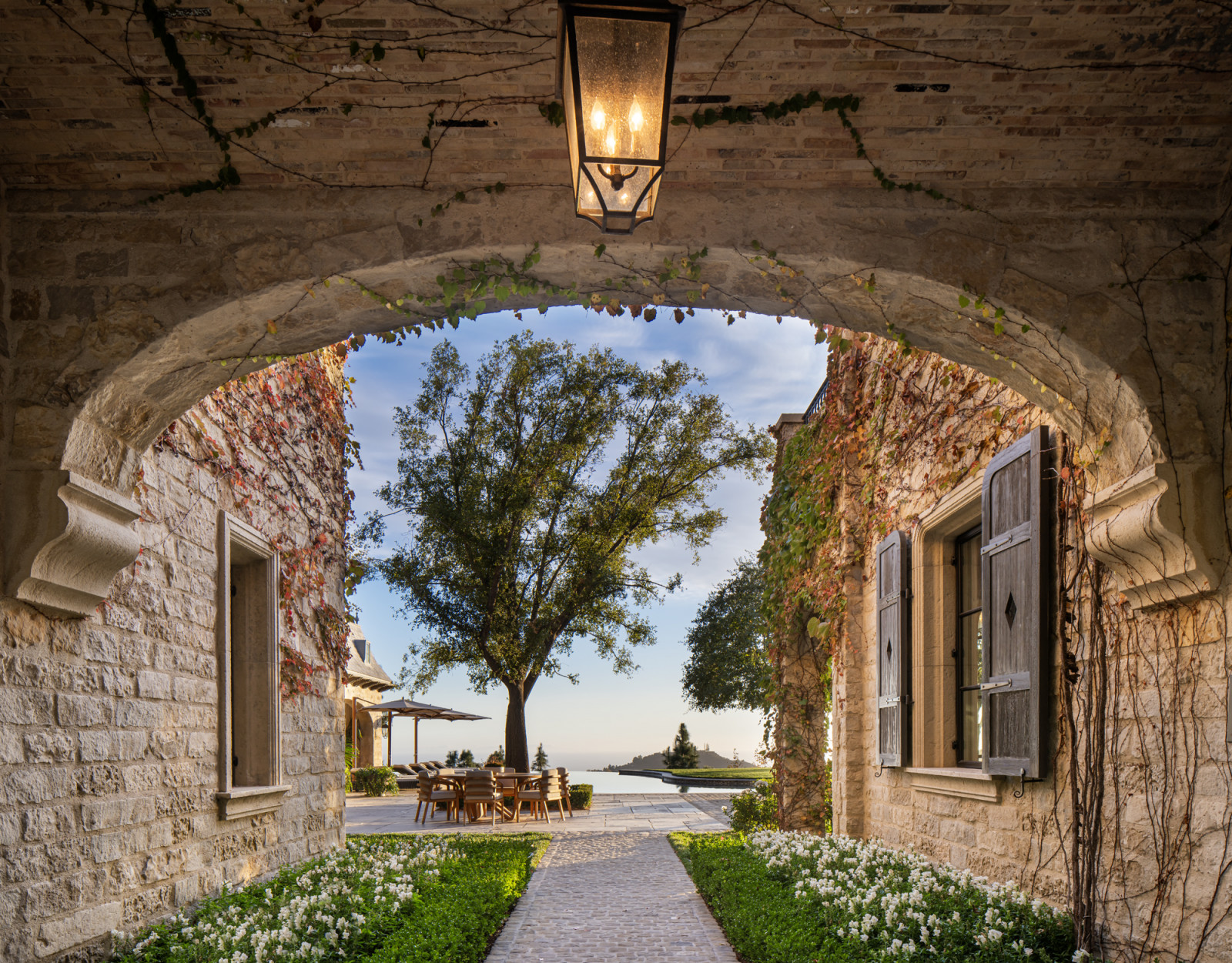 The majestic archway leading into the expansive backyard